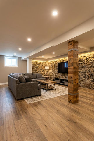 Cozy basement with stone wall and modern furnishings.