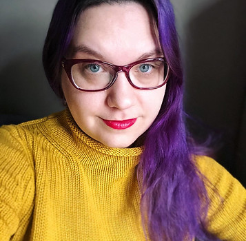 A Woman Wearing a Yellow Sweater with Purple Hair