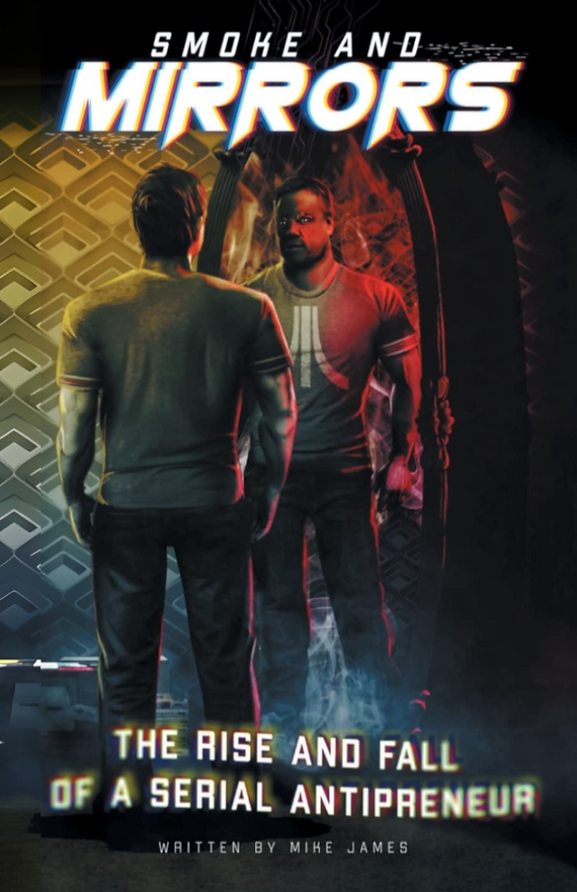 The English cover of "Smoke And Mirrors: The Rise and Fall of a Serial Antipreneur" by Mike James. On the cover, it has a CG image of a man, looking into a mirror with his reflection staring back at him. He has an Atari logo on his t-shirt and there's smoke rising up from the ground.