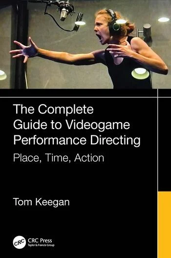 Cover of The Complete Guide to Videogame Performance Directing: Place, Time, Action by Tom Keegan. The top half features a photograph of a voice actor in a recording booth, wearing headphones and passionately delivering a performance with an intense expression and outstretched arms. The bottom half has a black and yellow design with white text, including the CRC Press logo, part of the Taylor & Francis Group.
