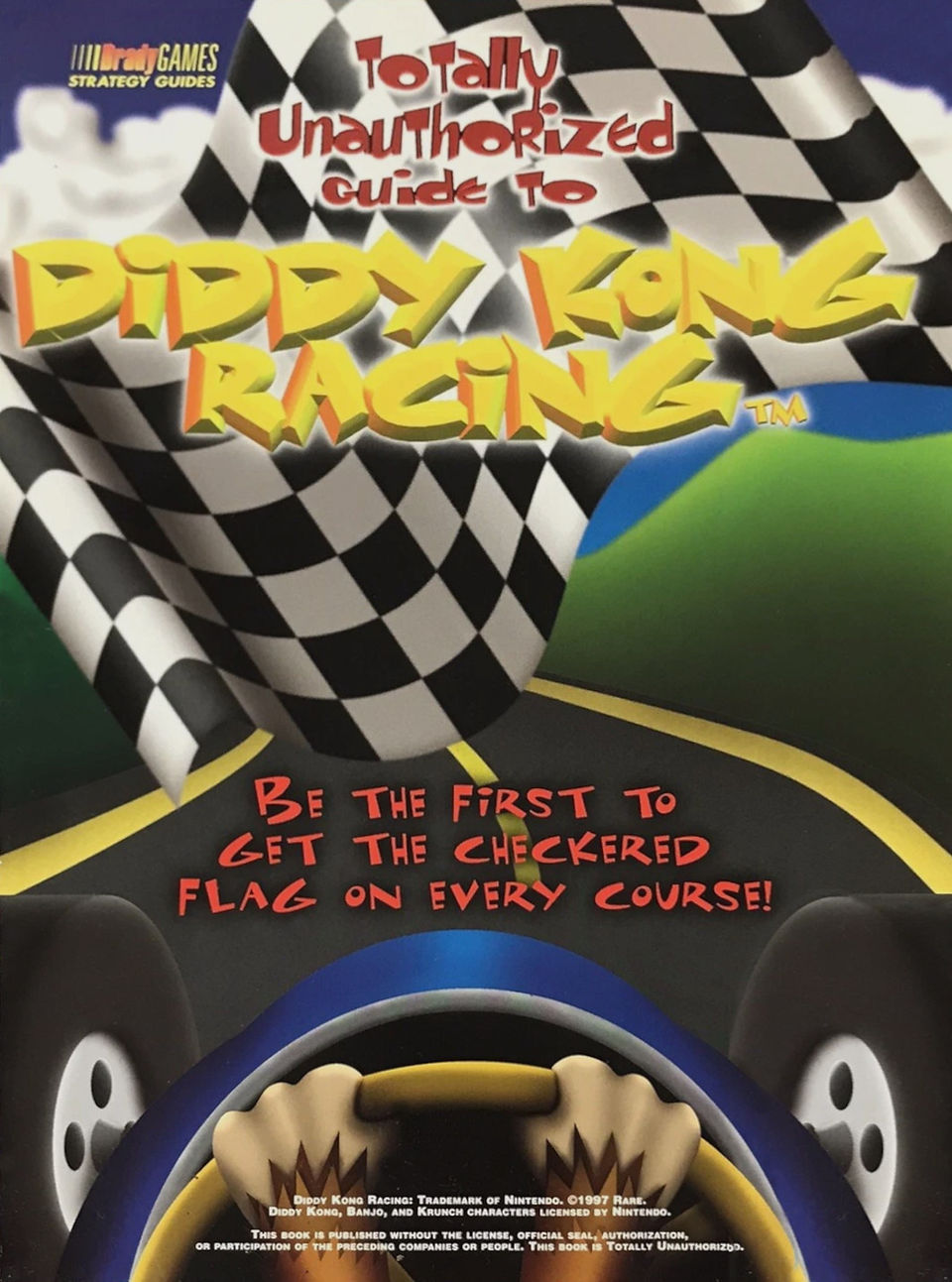 Cover of Totally Unauthorized Guide to Diddy Kong Racing by BradyGames, featuring a stylized racing scene with a giant checkered flag, a winding road, and a cartoon view from behind a racer's hands on the wheel. The title is in bold yellow and red lettering, with the tagline “Be the first to get the checkered flag on every course!” written in red text across the bottom.