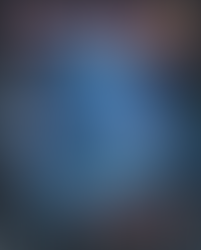 The cover features a dark, eerie blue-toned scene dominated by a translucent, glowing humanoid creature suspended inside a geometric, glass-like enclosure. The creature appears crystalline and distorted, with elongated limbs and sharp, blade-like protrusions, illuminated in icy blues and purples. Across the top, bold red and white text reads “THE HOUSE OF THE DEAD 2,” with “G’s FILE” prominently displayed to the right in large lettering. Japanese vertical text runs down the left side, and small pricing text appears near the upper right. The background suggests a metallic or industrial interior with vents and structural beams visible behind the glass framework. At the bottom, the title “THE HOUSE OF THE DEAD 2” appears again in a stylized horror-themed font with splattered detailing, reinforcing the dark, survival-horror aesthetic of the cover.