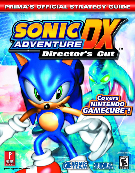 Prima’s official strategy guide cover for “Sonic Adventure DX Director’s Cut,” with a red top banner reading “PRIMA’S OFFICIAL STRATEGY GUIDE.” The large colorful title logo fills the upper portion, with “SONIC ADVENTURE DX” in yellow, blue, orange, and red letters and “Director’s Cut” in white on a black strip. Sonic appears prominently in the center foreground, shown in bright blue with green eyes, white gloves, and red shoes, posing with one hand extended toward the viewer. Behind him is a glowing turquoise creature-like figure against a vivid abstract background of blue, green, pink, and white light effects. A badge on the right reads “Covers NINTENDO GAMECUBE!” Along the bottom are the Prima Games logo, primagames.com, Sonic Team and Sega logos, and an Everyone ESRB rating box.