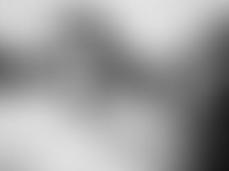 A tender moment as the bride's mother fastens her necklace before the ceremony.