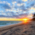 A beach with a sunrise.jpg