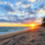 A beach with a sunrise.jpg