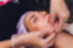 cosmetologist makes a buccal massage of the patient's facial muscles.