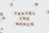 travel the world written with scrabble letters
