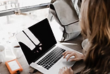 woman on laptop with backpack