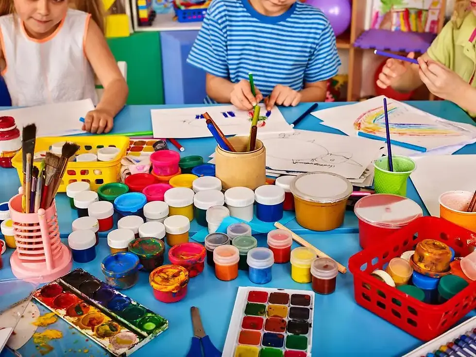 School students painting with brushes and poster colours