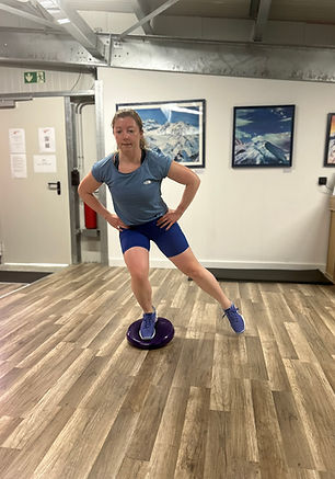 A person doing a balancing exercise on a balance disc.