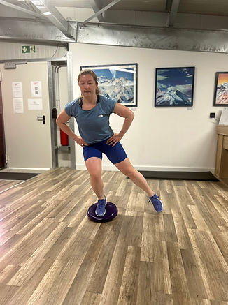 A person doing a balancing exercise on a balance disc.