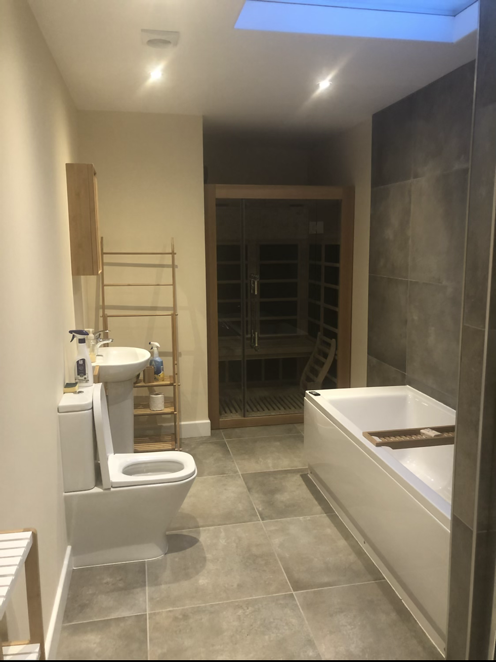 Wide angle view of a spacious accessible holiday cottage bathroom with natural light