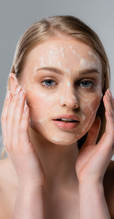 stock-photo-young-woman-blue-eyes-applying-cleansing-foam-face-isolated-grey.jpeg