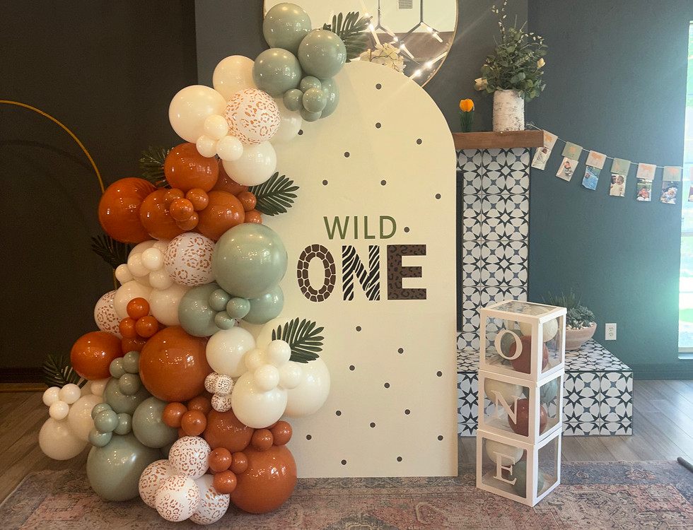 Baby shower balloon arch with sage green, cream, terracotta, and gold balloons and eucalyptus greenery, reading A Sweet Little Peanut Is On The Way, by Heyday and Co. in San Antonio.
