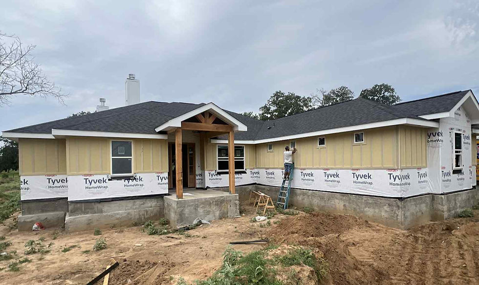 Eye-level view of a construction site with workers on a custom home