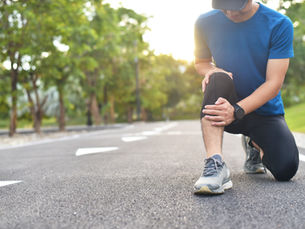 Man holding his knee - Possible Cruciate Ligament Tear