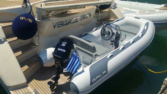 GALA inflatable tender with Greek flag behind a yacht