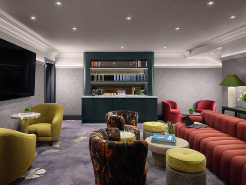 Stylish Fifty One London lounge with seating and bookshelves
