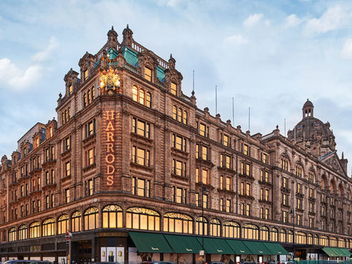 Harrods department store building, HARRODS sign, ornate London architecture.