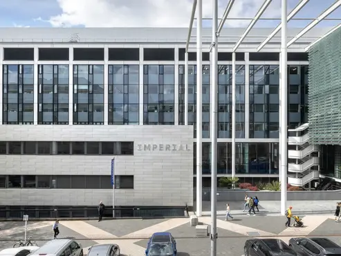 Modern British Library building features glass facade and white structural elements.