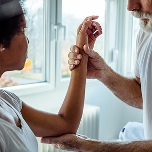 Physiotherapist examining a patient's tennis elbow injury