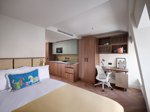 Modern studio apartment: bed, kitchenette, desk