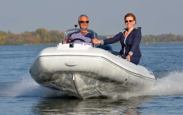 Couple in a white inflatable boat on water