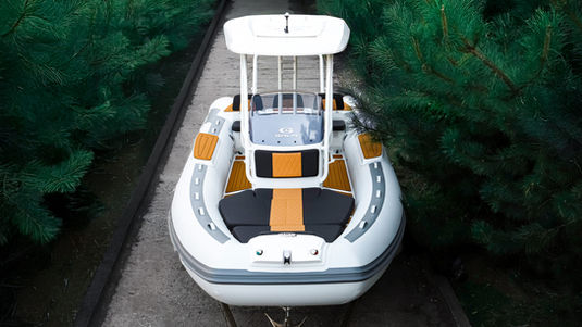 White and orange cruising boat on a path