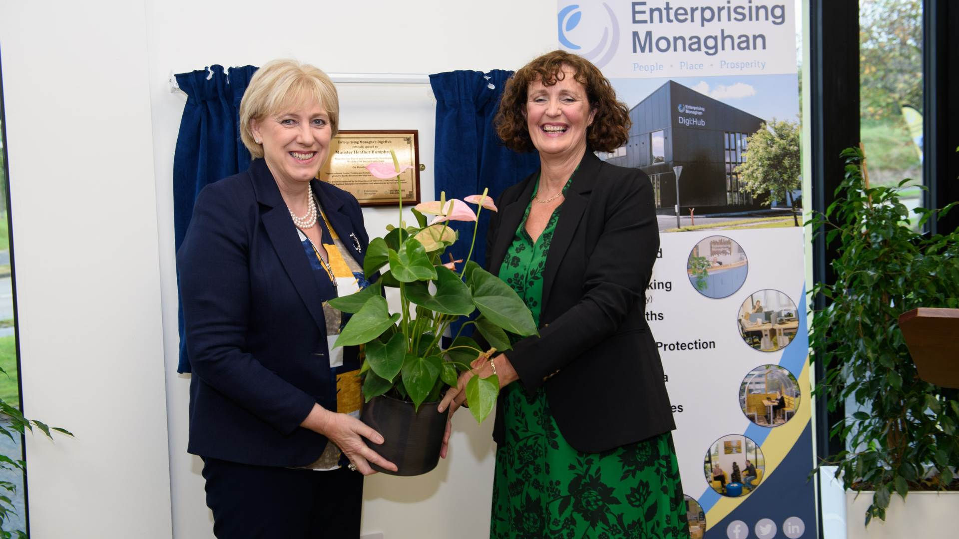 Newbliss Digi Hub opening: Two women at ribbon cutting ceremony with Enterprising Monaghan.