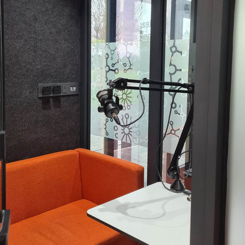 Orange seat and microphone in a podcasting studio recording Podcast