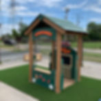 4' x 4' green kids playhouse with shelves, chalkboard, farmer's market sign, fruits and vegetables, & roof at daycare school