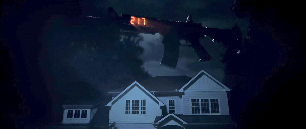 A gun floating over a house.