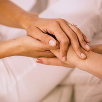 Two persons holding hands