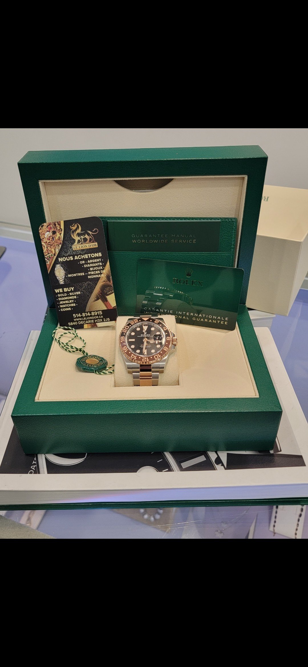 A watch with its presentation box — Le Lion d’Or