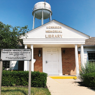 Exterior of Johnson Memorial Library in Hicksville, water tower in background
