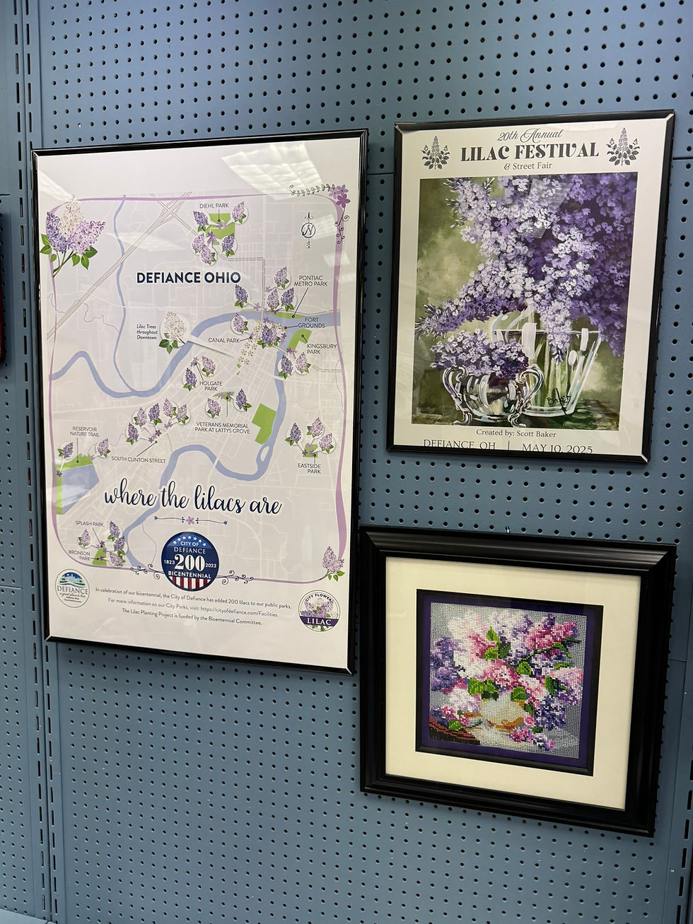 Lilac Festival posters & art on display in the Defiance Main Street & Visitors Bureau office.