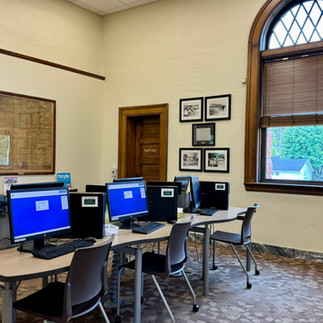 Several desktop computers set up in a brightly lit space