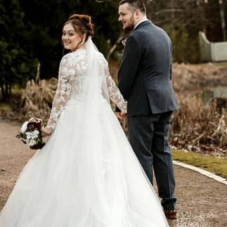 Elegant bride in 3D applique wedding dress with added lace jacket for personalised look