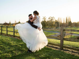 Bride wearing a Casablanca Bridal princess style wedding dress with a full tulle skirt and 3D floral details.