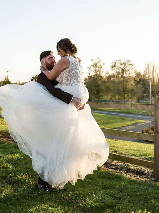 Bride wearing a Casablanca Bridal princess style wedding dress with a full tulle skirt and 3D floral details.