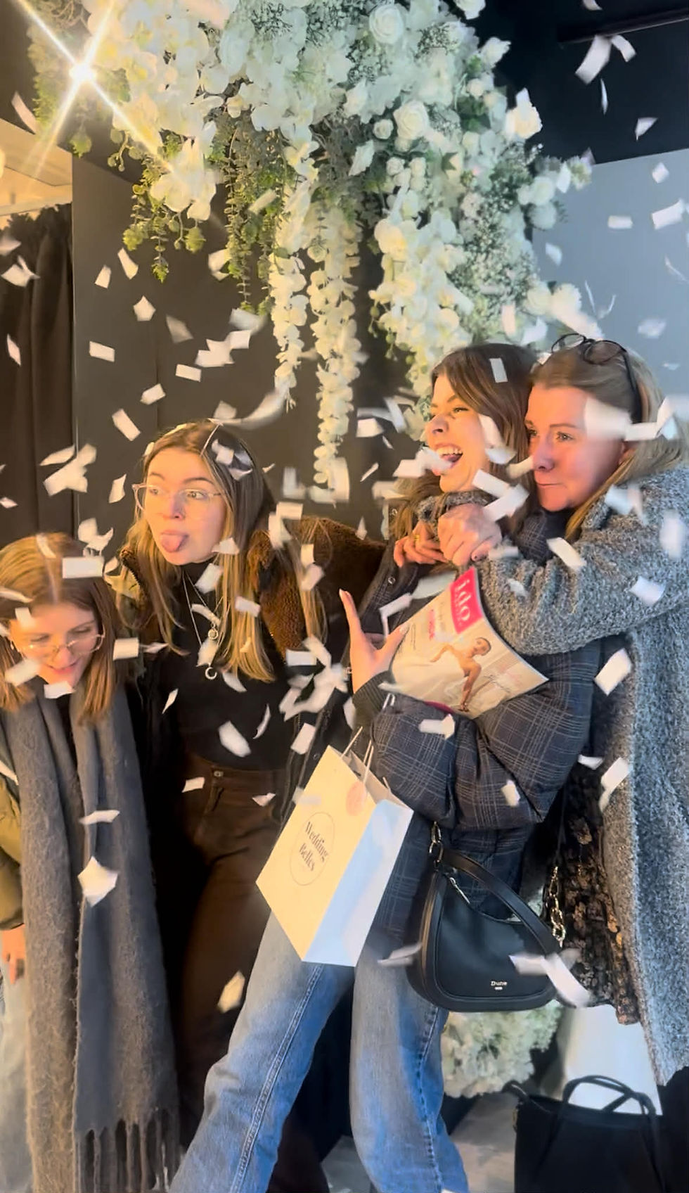 Styling area at Wedding Belles Love in Stone, Staffordshire, with soft lighting, mirrors, and a beautiful selection of bridal dresses.