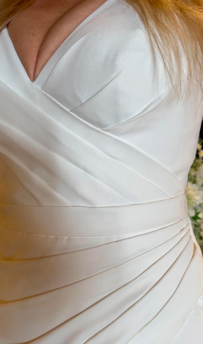 Cary by Mavery Hugh wedding dress size 14 ivory at Wedding Belles Love Stone Staffordshire featuring a draped satin bodice and elegant fit and flare silhouette.