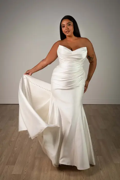 Stella York SY8346 plus size wedding dress at Wedding Belles Love in Staffordshire, featuring a strapless Mikado fit-and-flare silhouette with ruched bodice, structured corsetry and dramatic train.