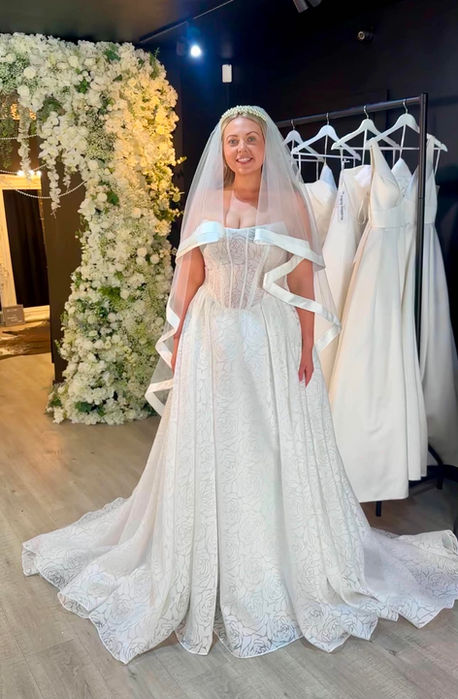 Celine by Mavery Hugh wedding dress size 14 ivory at Wedding Belles Love Stone Staffordshire featuring intricate rose jacquard fabric, corset bodice and dramatic ballgown silhouette.