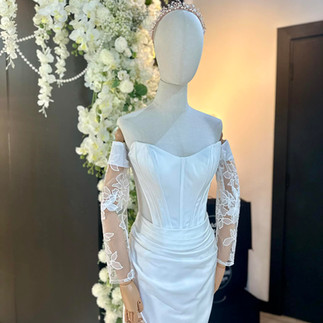 Fitted satin wedding dress styled with minimal accessories, showcasing its refined silhouette and luxurious texture