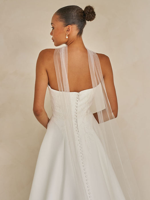 Wendall strapless A-line wedding gown in ivory velvet-finish satin with cascading botanical lace appliqués and a detachable tulle neck scarf, available at Wedding Belles Love, Staffordshire.