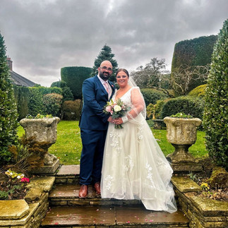 Couple holding hands during their wedding day in a cosy setting