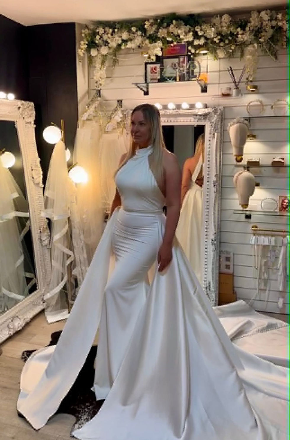 Sylvia by Mavery Hugh wedding dress size 12 ivory at Wedding Belles Love Stone Staffordshire featuring a halter neckline, fitted crepe silhouette and optional overskirt.