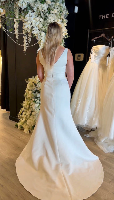 Cary by Mavery Hugh wedding dress size 14 ivory at Wedding Belles Love Stone Staffordshire featuring a draped satin bodice and elegant fit and flare silhouette.